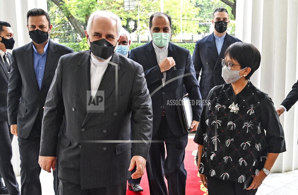 Uncredited In this photo released by Indonesian Ministry of Foreign Affairs, Indonesian Foreign Minister Retno Marsudi, right, walks with her Iranian counterpart Mohammad Javad Zarif during their meeting in Jakarta, Indonesia, Monday, April 19, 2021. (Indonesian Ministry of Foreign Affairs via AP)