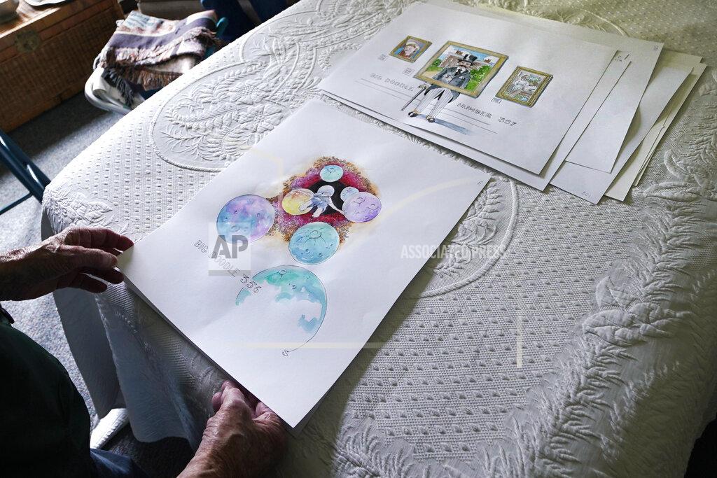 Charles Krupa Artist Robert Seaman reviews recent completed doodles in his room at an assisted living facility Monday, May 10, 2021, in Westmoreland, N.H. Seaman, who moved into the facility weeks before the COVID-19 pandemic shutdown his outside world in 2020, recently completed his 365th daily sketch, or what he calls his "Covid Doodles", since being isolated due to the virus outbreak. (AP Photo/Charles Krupa)