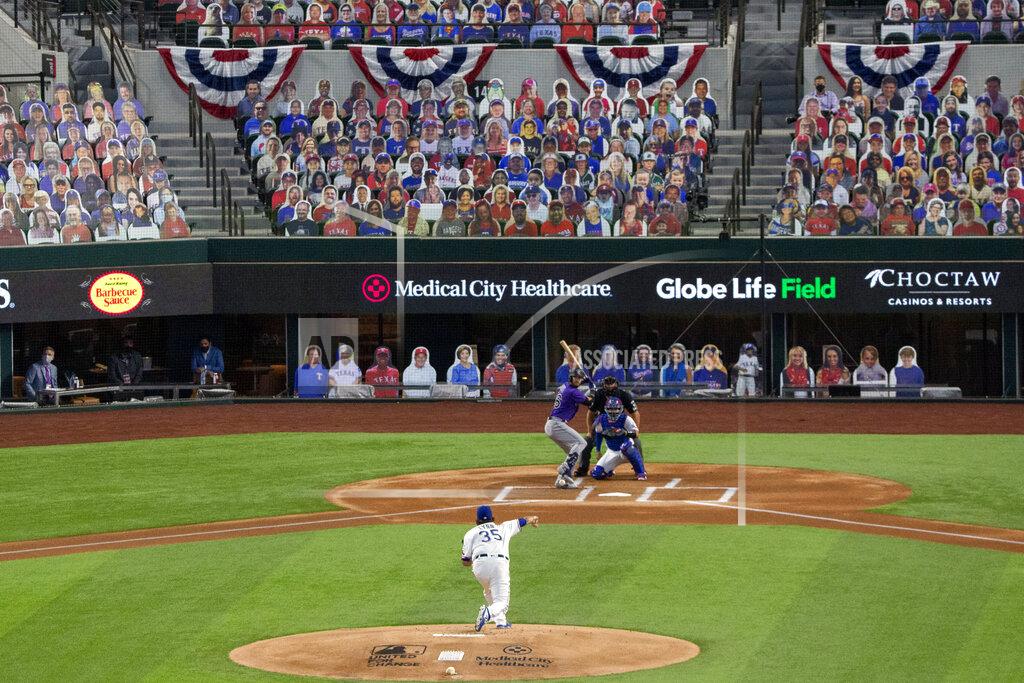Jeffrey Mcwhorter Texas Rangers starter Lance Lynn (35) throws the first pitch of an opening day baseball game to Colorado Rockies' David Dahl as Rangers' Robinson Chirinos catches and home plate umpire Jim Reynolds looks on Friday, July 24, 2020, in Arlington, Texas. The pitch was the first ever in a regular season game at Globe Life Field, the Rangers' new ballpark. (AP Photo/Jeffrey McWhorter)