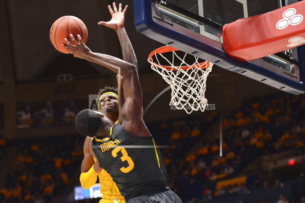 William Wotring West Virginia guard Malik Curry (10) blocks the dunk by Baylor guard Dale Bonner (3) during the second half of an NCAA college basketball game in Morgantown, W.Va., Tuesday, Jan. 18, 2022. (William Wotring)