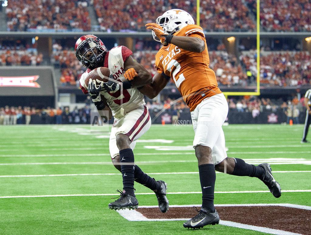 Jeffrey Mcwhorter Texas defensive back Kris Boyd (2) breaks up a pass in the end zone intended for Oklahoma wide receiver Marquise Brown (5) during the first half of the Big 12 Conference championship NCAA college football game on Saturday, Dec. 1, 2018, in Arlington, Texas. (AP Photo/Jeffrey McWhorter)