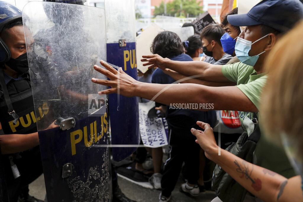 Basilio Sepe Police block activists protesting the upcoming proclamation of presidential frontrunner Ferdinand "Bongbong" Marcos and running mate Sara Duterte, daughter of the current president, during a rally at the Commission on Human Rights in Quezon City, Metro Manila, Marcos Jr. continues to lead in the official canvassing of votes. (AP Photo/Basilio Sepe)