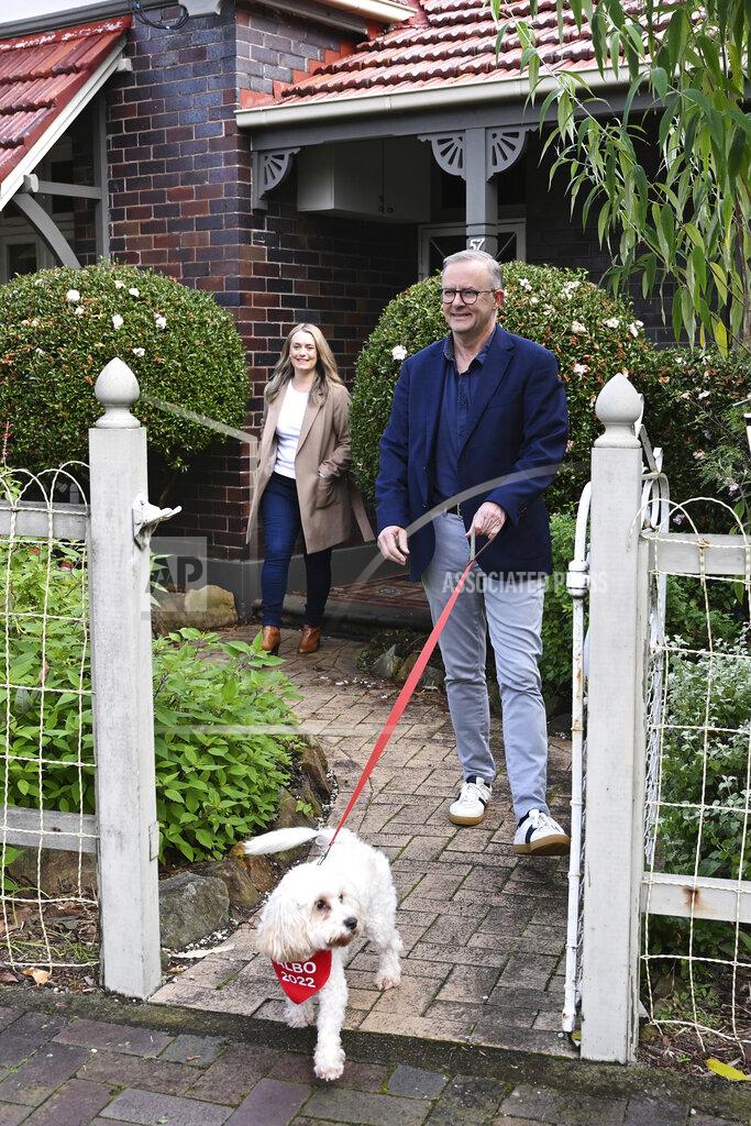 Dean Lewins Australia's Prime Minister-elect Anthony Albanese, right, and his partner Jodie Haydon go for a walk with their dog, Toto, in Sydney, Sunday, May 22, 2022. Albanese has promised to rehabilitate Australia's international reputation as a climate change laggard with steeper cuts to greenhouse gas emissions. (Dean Lewins/AAP Image via AP)