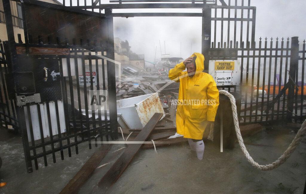 Eric Gay Jame Rowles examines the damage after the docks at the marina where his boat was secured were destroyed as Hurricane Hanna made landfall, Saturday, July 25, 2020, in Corpus Christi, Texas. (AP Photo/Eric Gay)