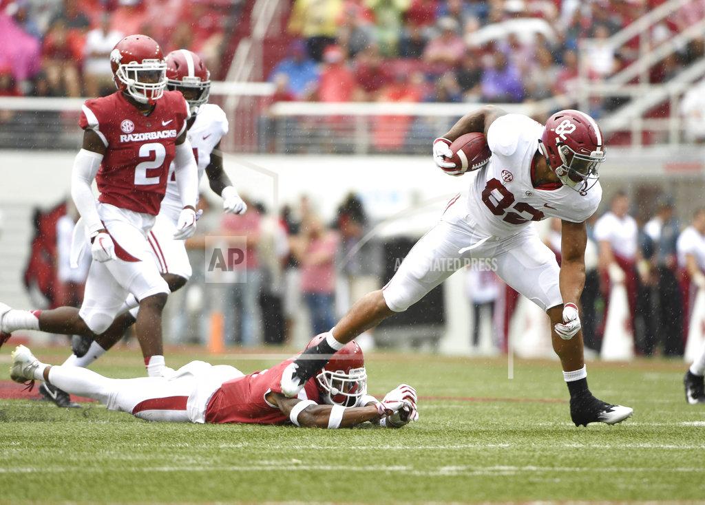 Michael Woods Alabama receiver Gary Cross slips past Arkansas defender Santos Ramirez in the first half of an NCAA college football game Saturday, Oct. 6, 2018, in Fayetteville, Ark. (AP Photo/Michael Woods)