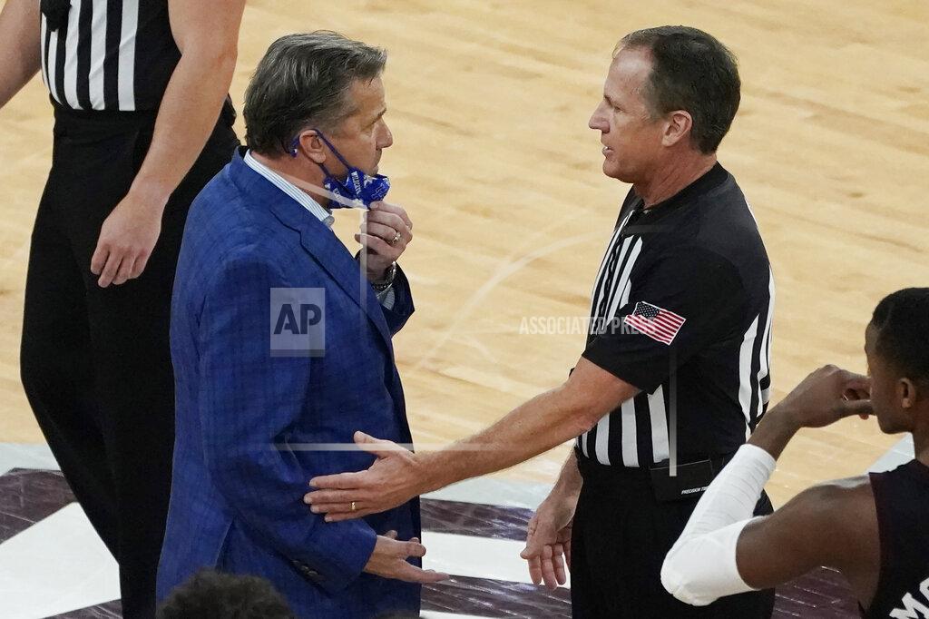 Rogelio V. Solis Kentucky head coach John Calipari, left, confers with an official after being tossed out of an NCAA college basketball game against Mississippi State during the second half in Starkville, Miss., Saturday, Jan. 2, 2021. (AP Photo/Rogelio V. Solis)
