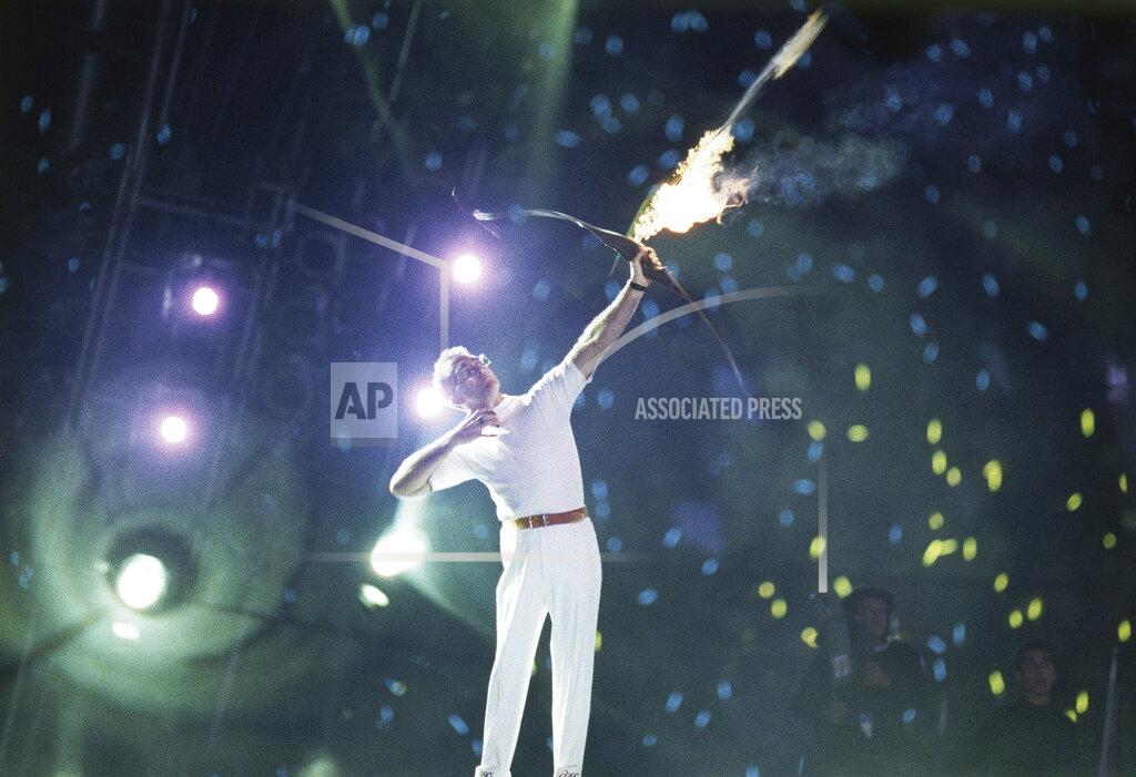 Dominique Mollard An arrow carrying the Olympic flame leaves the bow of Antonio Rebollo to light the Olympic Torch and open the XXV Olympic in Barcelona Saturday night, July 25, 1992. (AP Photo/ Dominique Mollard)