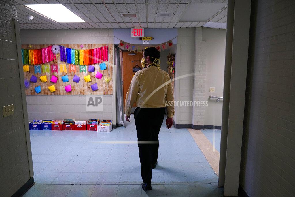 Matt Slocum Principal Rob Palazzo walks down a hall at Panther Valley Elementary School, Thursday, March 11, 2021, in Nesquehoning, Pa. On May 26, 2020, former student, 9-year-old Ava Lerario; her mother, Ashley Belson, and Ava's father, Marc Lerario, were found fatally shot inside their home. Palazzo says he and the rest of the school and community are grappling with the what-ifs: What if school had been open, and they had a chance to save Ava? (AP Photo/Matt Slocum)