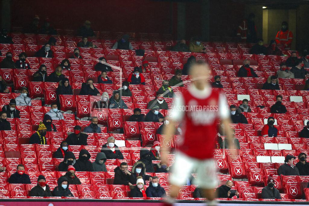 Catherine Ivill Arsenal fans sit in spaced out seats for coronavirus rules during an English Premier League soccer match between Arsenal and Burnley at the Emirates stadium in London, England, Sunday Dec. 13, 2020. (Catherine Ivill/Pool via AP)