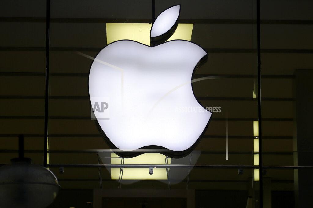 Matthias Schrader The logo of Apple is illuminated at a store in the city center in Munich, Germany, Wednesday, Dec. 16, 2020. After the U.S. Supreme Court revoked the federal right to an abortion that's been in place for half a century, companies like Amazon, Disney, Apple and JP Morgan pledged to cover travel costs for employees who live in states where the procedure is now illegal so they can terminate pregnancies. (AP Photo/Matthias Schrader)