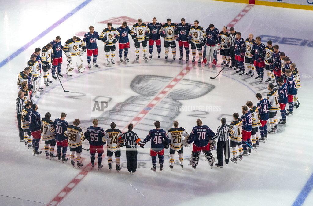 Frank Gunn The Boston Bruins and the Columbus Blue Jackets stand together for the national anthems prior to NHL hockey exhibition game action in Toronto, Thursday, July 30, 2020. (Frank Gunn/The Canadian Press via AP)