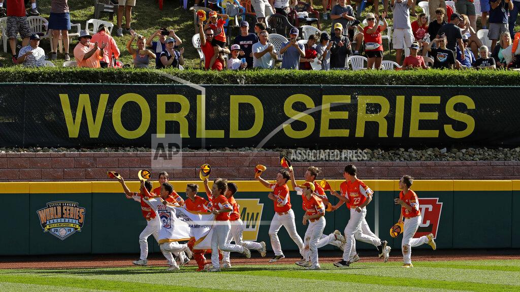 Gene J. Puskar FILE - In this Sunday, Aug. 25, 2019, file photo, River Ridge, Louisiana, takes a victory lap around the field at Lamade Stadium after winning the Little League World Series Championship game against Curacao, 8-0, in South Williamsport, Pa. The 2020 Little League World Series and the championship tournaments in six other Little League divisions have been canceled because of the new coronavirus pandemic. (AP Photo/Gene J. Puskar, File)