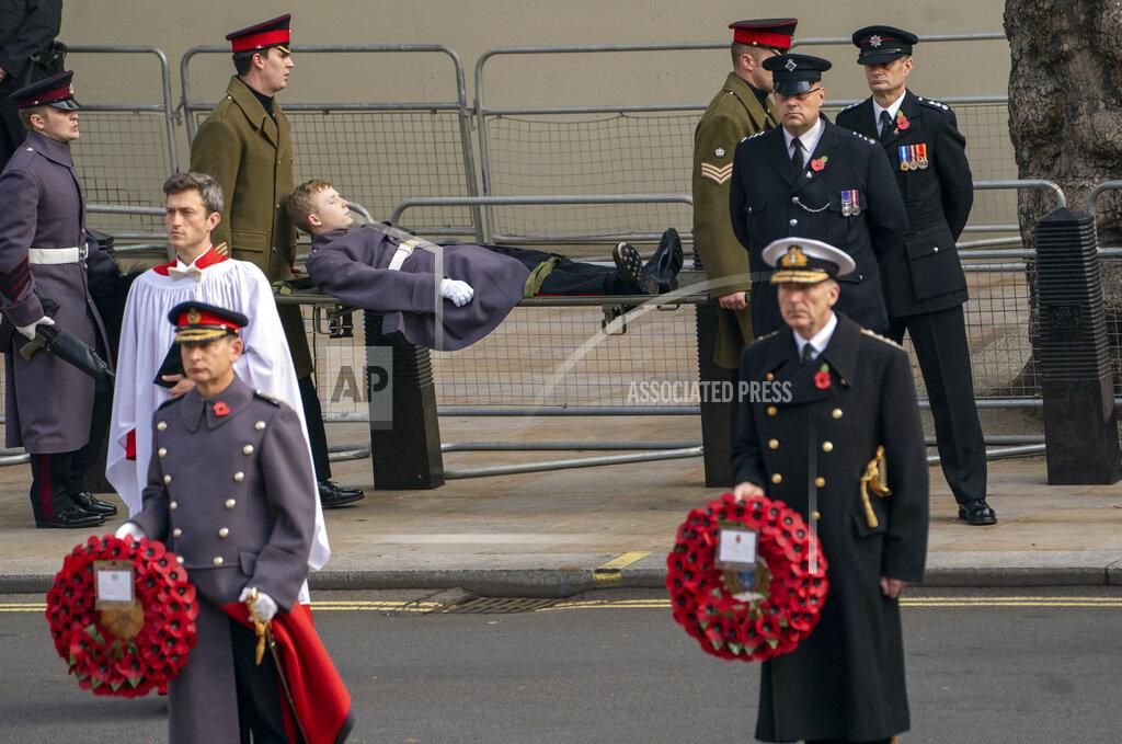 Arthur Edwards A member of the armed forces is carried away on a stretcher , during the Remembrance Sunday service at the Cenotaph, in Whitehall, London, Sunday Nov. 8, 2020. (Arthur Edwards/Pool Photo via AP)