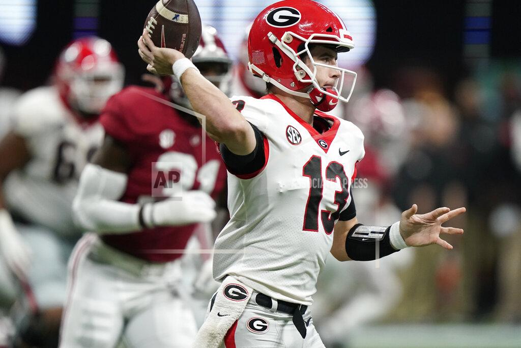 Georgia quarterback Stetson Bennett (13) passes the ball against Alabama during the first half of the Southeastern Conference championship NCAA college football game, Saturday, Dec. 4, 2021, in Atlanta. (AP Photo/Brynn Anderson)