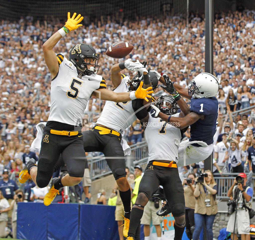 Chris Knight FILE - In this Sept. 1, 2018, file photo, Appalachian State defenders Thomas Hennigan (5), Corey Sutton (2) and Josh Thomas (7), break up a pass intended for Penn State's KJ Hamler (1) in the end zone during the first half of an NCAA college football game, in State College, Pa. Bolstered by its first Top 25 ranking in the history of its program, No. 25 Appalachian State will face longtime rival Georgia Southern in a Sun Belt showdown on Thursday night. (AP Photo/Chris Knight, File)