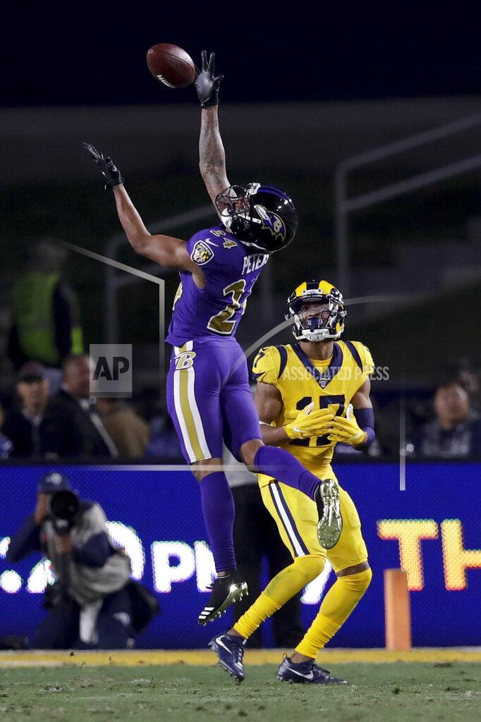 Marcio Jose Sanchez Baltimore Ravens cornerback Marcus Peters intercepts a pass intended for Los Angeles Rams wide receiver Robert Woods during the second half of an NFL football game Monday, Nov. 25, 2019, in Los Angeles. (AP Photo/Marcio Jose Sanchez)