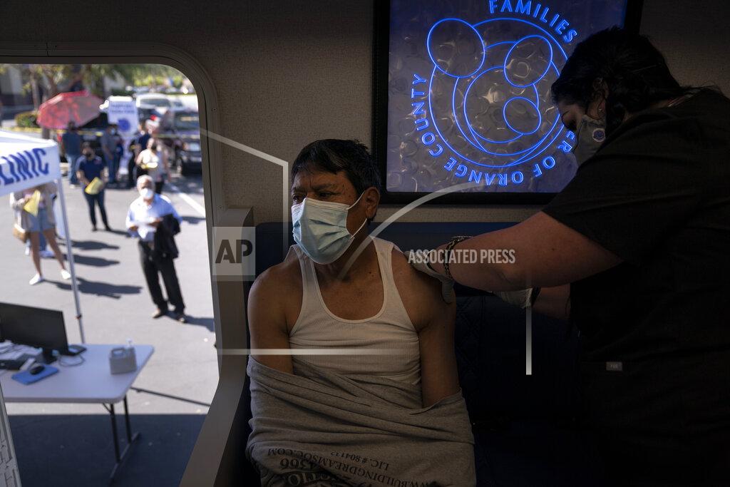 Jae C. Hong Nurse Natasha Garcia administers a dose of the Moderna COVID-19 vaccine to Samuel Sanchez in a mobile clinic set up in the parking lot of a shopping center in Orange, Calif., Thursday, April 29, 2021. The mobile unit, launched in February by Families Together of Orange County, began its service to provide better access to the COVID-19 vaccine within the community and to prevent vaccine hesitation, according to mobile operations manager Parsia Jahanbani. "There's a lot of people that are hesitant to go to vaccine centers to get vaccinated for various reasons. They might be afraid of not having paperwork. They might be afraid of not being able to take time off from work," said Jahanbani. (AP Photo/Jae C. Hong)
