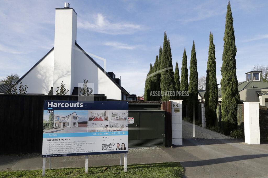 FILE - In this Aug. 13, 2018, file photo a house is pictured for sale in Christchurch, New Zealand. New Zealand will spend billions of dollars to encourage more home building and will also remove some tax breaks for speculators as it tries to slow skyrocketing house prices. The government on Tuesday announced a series of new measures to address what Prime Minister Jacinda Ardern is describing as a crisis.(AP Photo/Mark Baker, File)