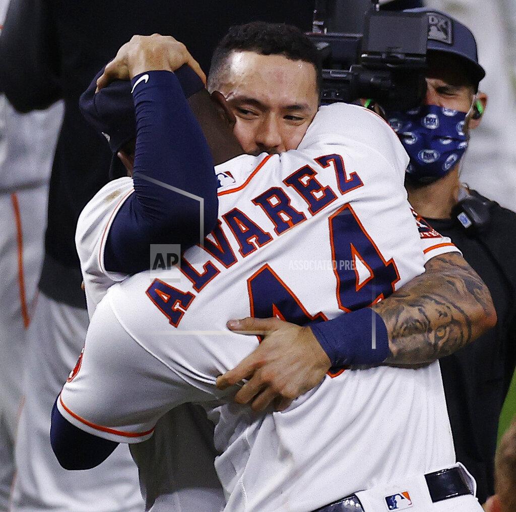 Kevin M. Cox Houston Astros shortstop Carlos Correa embraces designated hitter Yordan Alvarez after the Astros defeated the Boston Red Sox 5-0 in Game 6 of the baseball AL Championship Series, Friday, Oct. 22, 2021, in Houston. The Astros advanced to the World Series. (Kevin M. Cox/The Galveston County Daily News via AP)