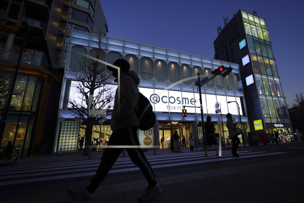 Eugene Hoshiko People walk past @cosme TOKYO, a store selling a selection of cosmetics and makeup products including men's cosmetic, in Tokyo's Harajuku district Tuesday, Feb. 9, 2021. The coronavirus pandemic has been pushing businesses to the edge in Japan, but some in the men's beauty industry have seen an unexpected expansion in their customer base. Japanese businessmen in their 40s, 50s and 60s who had little interest in cosmetics before the pandemic are now buying makeup. (AP Photo/Eugene Hoshiko)