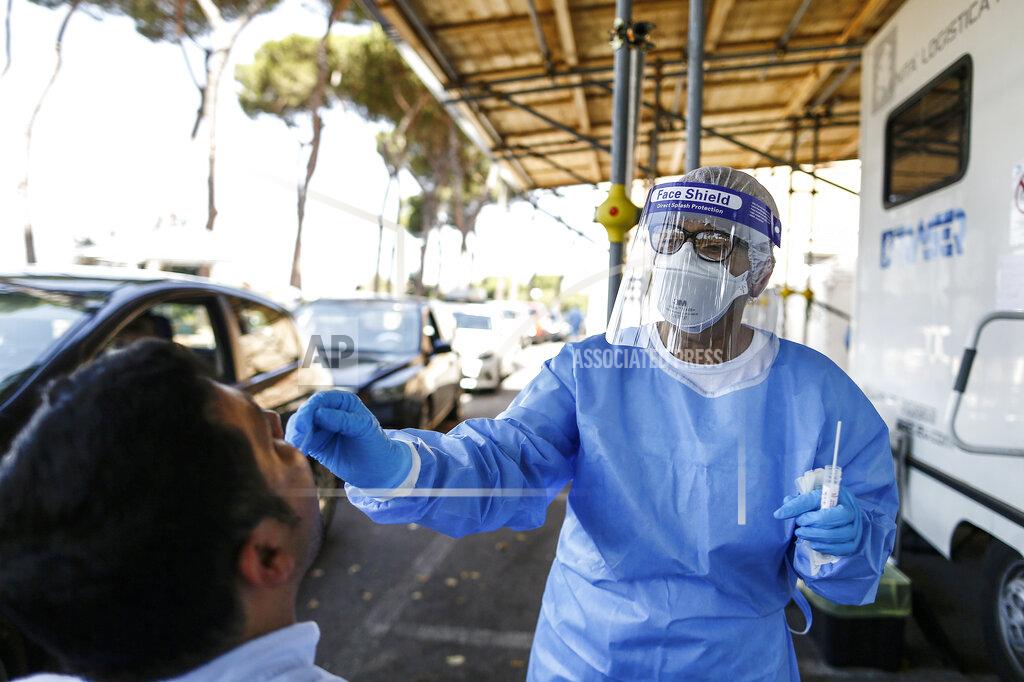 Cecilia Fabiano A man undergoes testing for COVID-19 at Rome's San Giovanni Addolorata hospital, Friday, Aug. 14, 2020. Italy is imposing mandatory testing on anyone arriving from Greece, Spain, Malta and Croatia as the number of new confirmed cases of coronavirus continues to nudge up with new cases recorded in every region of the country, often imported from abroad. (Cecilia Fabiano/LaPresse via AP)
