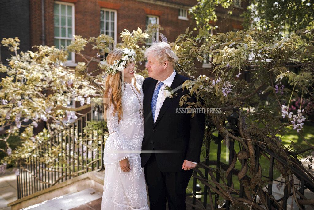 Rebecca Fulton In this image released Sunday May 30, 2021, by Downing Street, Britain's Prime Minister Boris Johnson and Carrie Johnson pose together for a photo in the garden of 10 Downing Street after their wedding on Saturday. Boris Johnson and his fiancée Carrie Symonds are newlyweds, according to an announcement from his Downing Street office saying they were married Saturday in a small private ceremony in London. (Rebecca Fulton/Downing Street via AP)