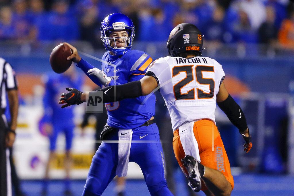Steve Conner Boise State quarterback Hank Bachmeier (19) is pressured by Oklahoma State safety Jason Taylor II (25) during the second half of an NCAA college football game Saturday, Sept. 18, 2021, in Boise, Idaho. (AP Photo/Steve Conner)