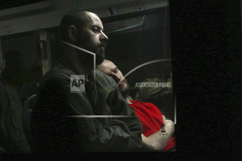 Uncredited Ukrainian servicemen sit in a bus after they were evacuated from the besieged Mariupol's Azovstal steel plant, near a prison in Olyonivka, in territory under the government of the Donetsk People's Republic, eastern Ukraine, Tuesday, May 17, 2022. More than 260 fighters, some severely wounded, were pulled from a steel plant on Monday that is the last redoubt of Ukrainian fighters in the city and transported to two towns controlled by separatists, officials on both sides said. (AP Photo)