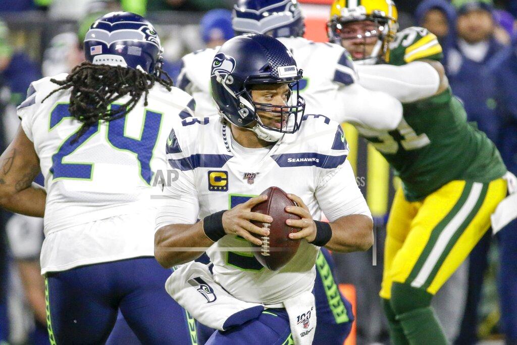 Mike Roemer Seattle Seahawks quarterback Russell Wilson drops back during the first half of an NFL divisional playoff football game against the Green Bay Packers Sunday, Jan. 12, 2020, in Green Bay, Wis. (AP Photo/Mike Roemer)