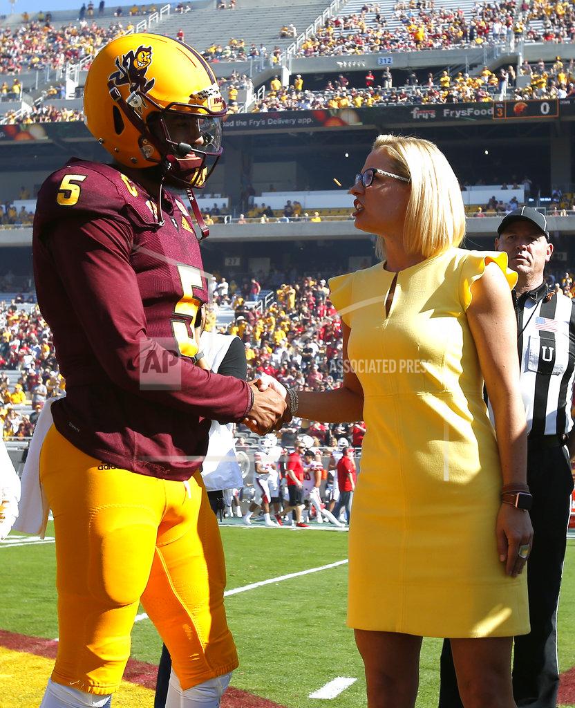 Rick Scuteri Democratic U.S. Senate candidate Kyrsten Sinema shakes hands with Arizona State's Kobe Williams during the coin toss before an NCAA college football game against Utah, Saturday, Nov 3, 2018, in Tempe, Ariz. (AP Photo/Rick Scuteri)