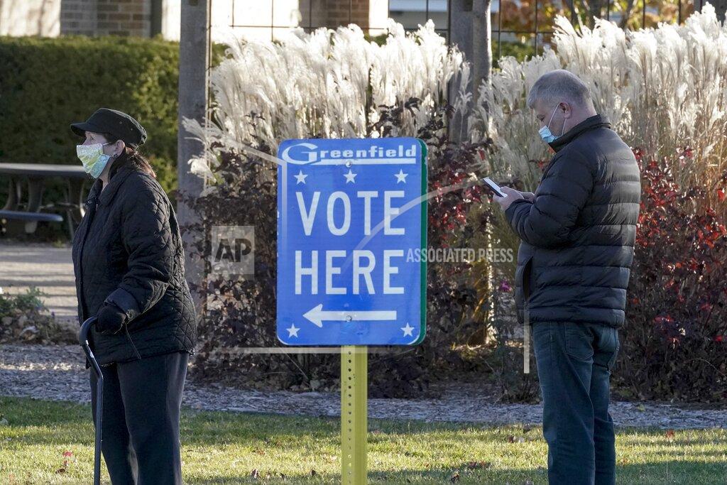 Morry Gash People line up to vote outside the Greenfield Community Center Tuesday, Nov. 3, 2020, in Greenfield, Wis. (AP Photo/Morry Gash)
