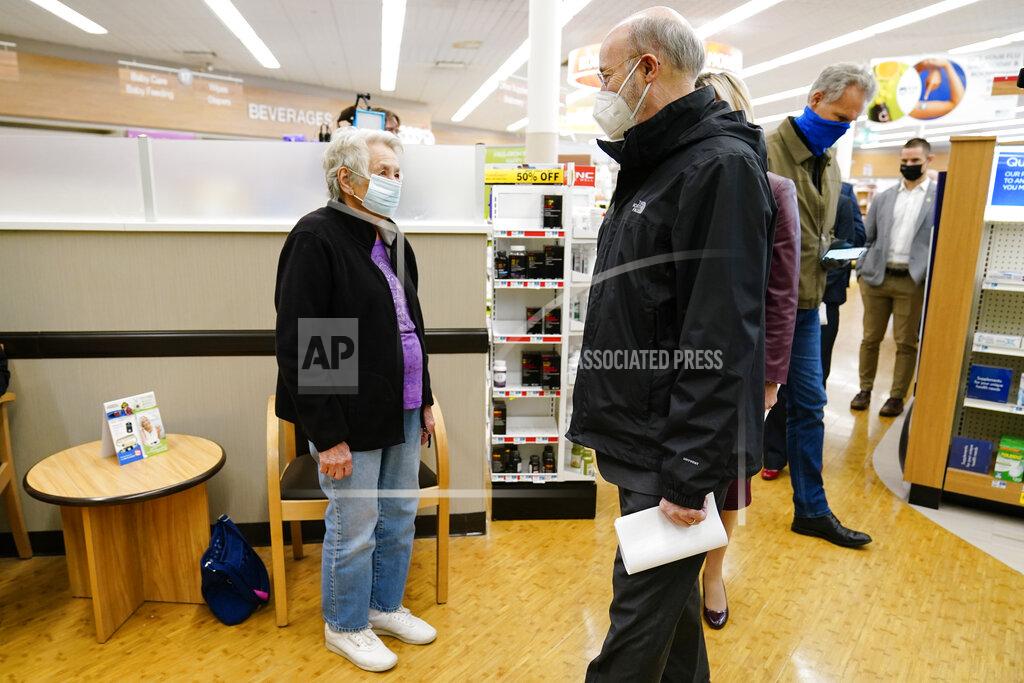 Matt Rourke Pennsylvania, Gov. Tom Wolf speaks with Darlene Morris, 83, as she waits to receive a COVID-19 vaccine at a Rite-Aid pharmacy in Steelton, Pa., Friday, March 5, 2021. (AP Photo/Matt Rourke)