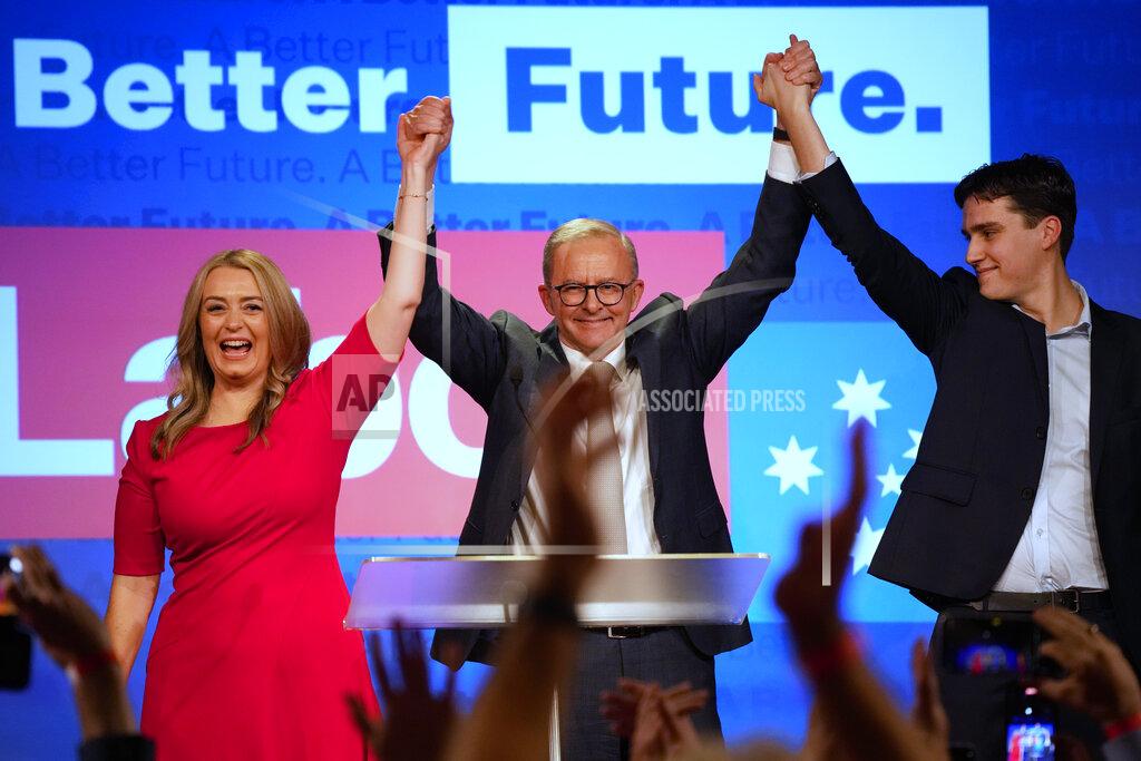 Rick Rycroft Labor Party leader Anthony Albanese, center, celebrates with his son Nathan, right, and his partner Jodie Haydon at a Labor Party event in Sydney, Australia, Sunday, May 22, 2022, after Prime Minister Scott Morrison conceding defeat to Albanese in a federal election. (AP Photo/Rick Rycroft)