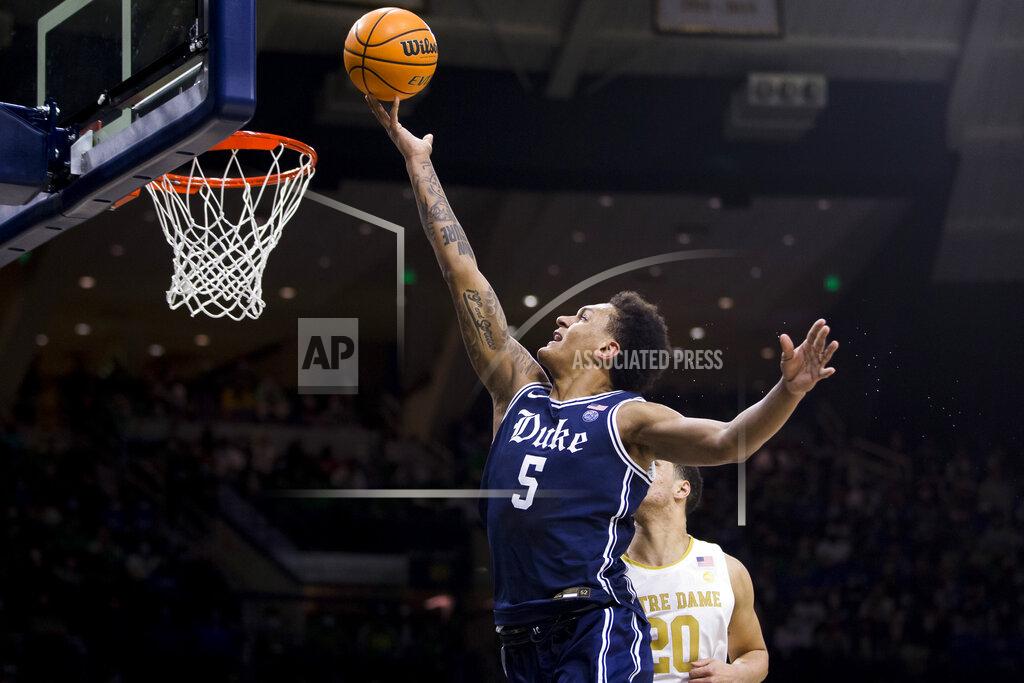 Robert Franklin Duke's Paolo Banchero (5) lays up next to Notre Dame's Paul Atkinson Jr. (20) during the first half of an NCAA college basketball game Monday, Jan. 31, 2022, in South Bend, Ind. (AP Photo/Robert Franklin)