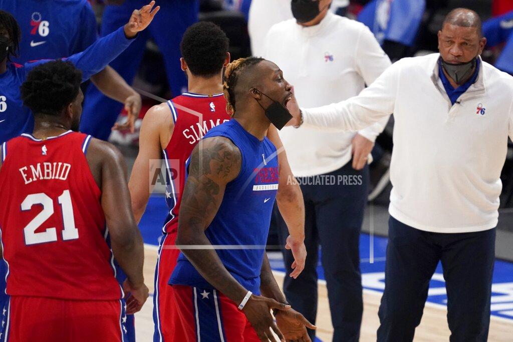 Tony Gutierrez Philadelphia 76ers' Joel Embiid (21), Dwight Howard, center and head coach Doc Rivers, right, celebrate during a time out in the second half of an NBA basketball game against the Dallas Mavericks in Dallas, Monday, April 12, 2021. The 76ers won 113-95. (AP Photo/Tony Gutierrez)