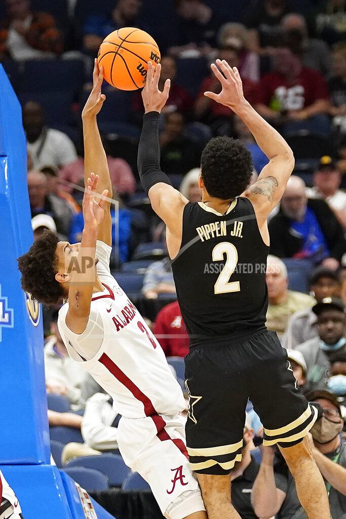 Chris O'meara Alabama forward Darius Miles, left, blocks a shot by Vanderbilt guard Scotty Pippen Jr., right, during the first half of an NCAA men's college basketball Southeastern Conference tournament game Thursday, March 10, 2022, in Tampa, Fla. (AP Photo/Chris O'Meara)