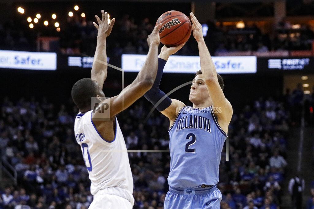 John Minchillo Villanova's Collin Gillespie (2) shoots against Seton Hall's Quincy McKnight (0) during the first half of an NCAA college basketball game, Wednesday, March 4, 2020, in Newark, N.J. (AP Photo/John Minchillo)
