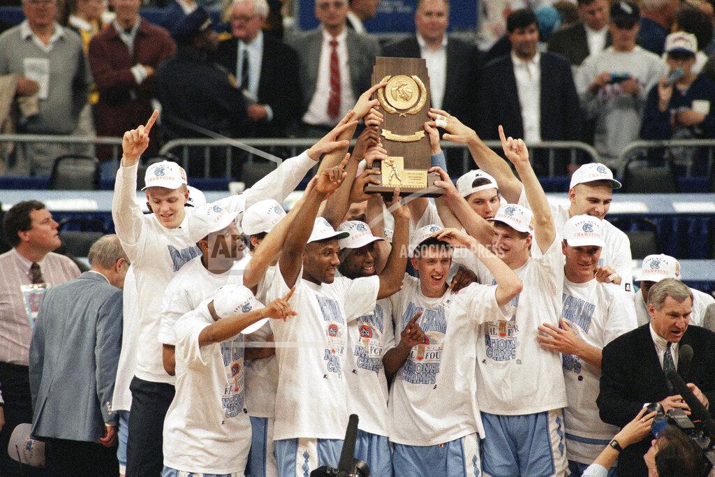 Bob Jordan FILE - In this Monday, April 5, 1993, file photo, North Carolina poses with the trophy after defeating Michigan 77-71 in the NCAA Final Four Championship game at the Superdome in New Orleans, La. At far right is coach Dean Smith. Smith won his second national championship, and like the first title he won at the Superdome, this one wasn’t sealed until somebody made a costly, almost unbelieveable, error. (AP Photo/Bob Jordan, File)