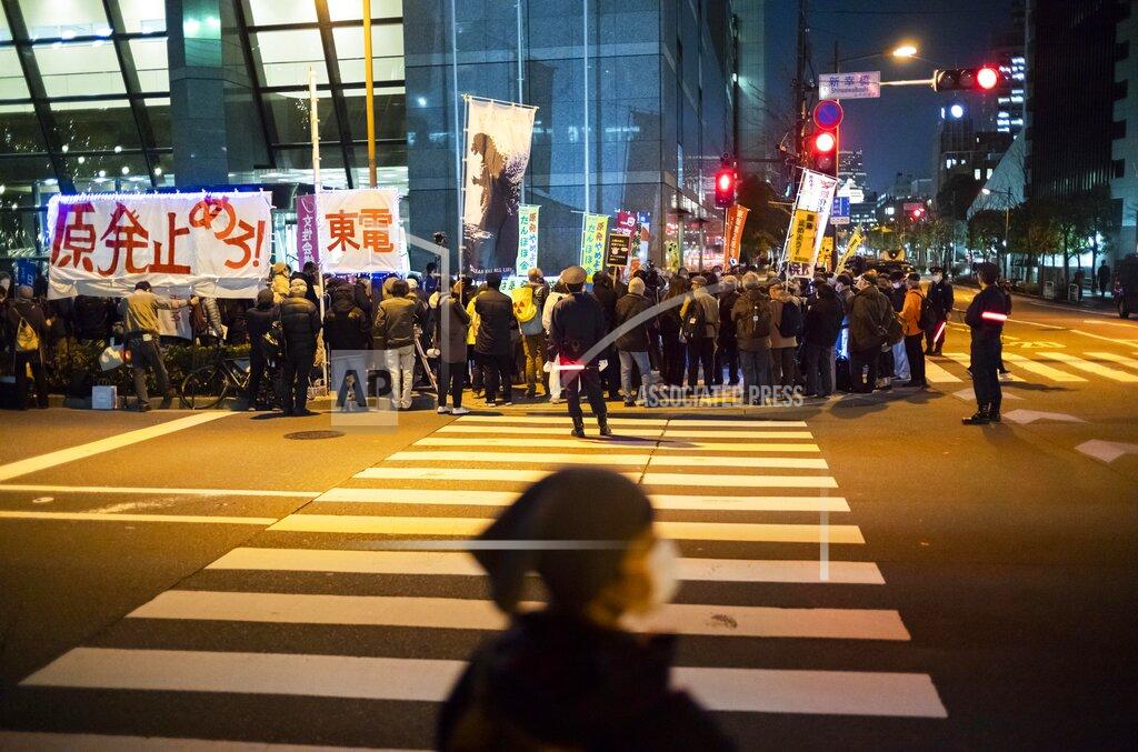 Hiro Komae Members of anti-nuclear plant groups and their supporters participate in a protest across from the Tokyo Electric Power Co. headquarters in Tokyo on Thursday, March 11, 2021. The banner, from left, reads, "Stop nuclear power plants!" and "TEPCO," or Tokyo Electric Power Co. An earthquake 10-years ago, set off a tsunami and nuclear crisis that devastated the country’s northeast coast.(AP Photo/Hiro Komae)
