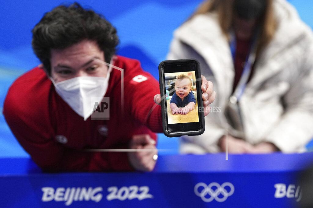 David J. Phillip Keegan Messing, of Canada, reacts after the men's short program figure skating competition at the 2022 Winter Olympics, Tuesday, Feb. 8, 2022, in Beijing. (AP Photo/David J. Phillip)