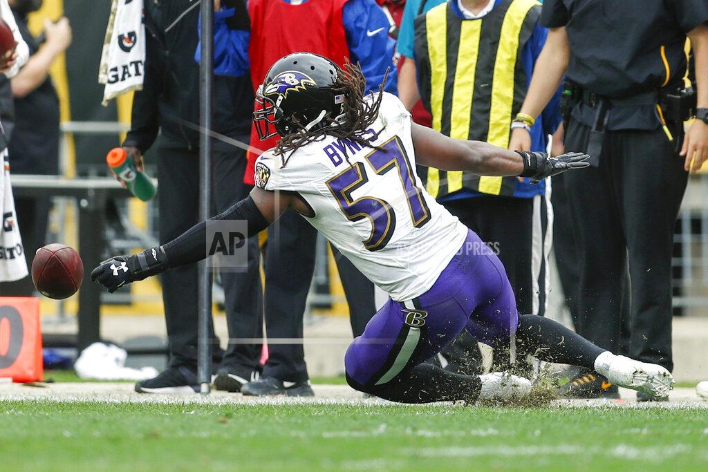 Don Wright Baltimore Ravens linebacker Josh Bynes (57) reaches for the ball fumbled by Pittsburgh Steelers wide receiver JuJu Smith-Schuster (19) during overtime of an NFL football game, Sunday, Oct. 6, 2019, in Pittsburgh. Ravens cornerback Marlon Humphrey recovered fumble. The Ravens won 26-23. (AP Photo/Don Wright)