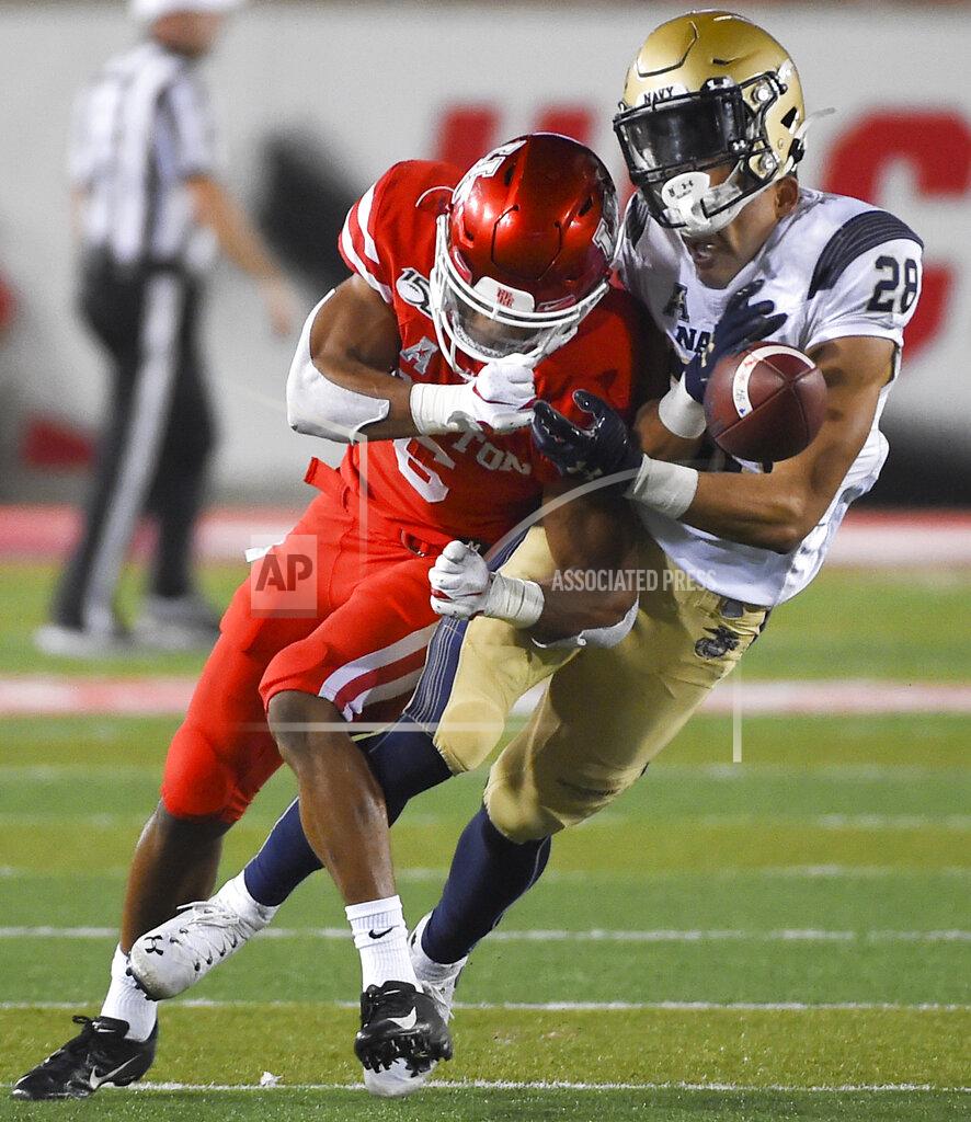 Eric Christian Smith Navy wide receiver Keoni-Kordell Makekau, right, is hit by Houston cornerback Damarion Williams during the second half of an NCAA college football game, Saturday, Nov. 30, 2019, in Houston. (AP Photo/Eric Christian Smith)