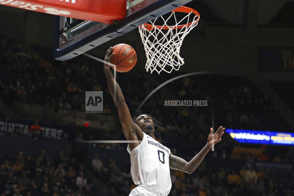 Kathleen Batten West Virginia guard Kedrian Johnson (0) shoots during the second half of an NCAA college basketball game against Morehead State in Morgantown, W.Va., Tuesday, Nov. 15, 2022. (AP Photo/Kathleen Batten)