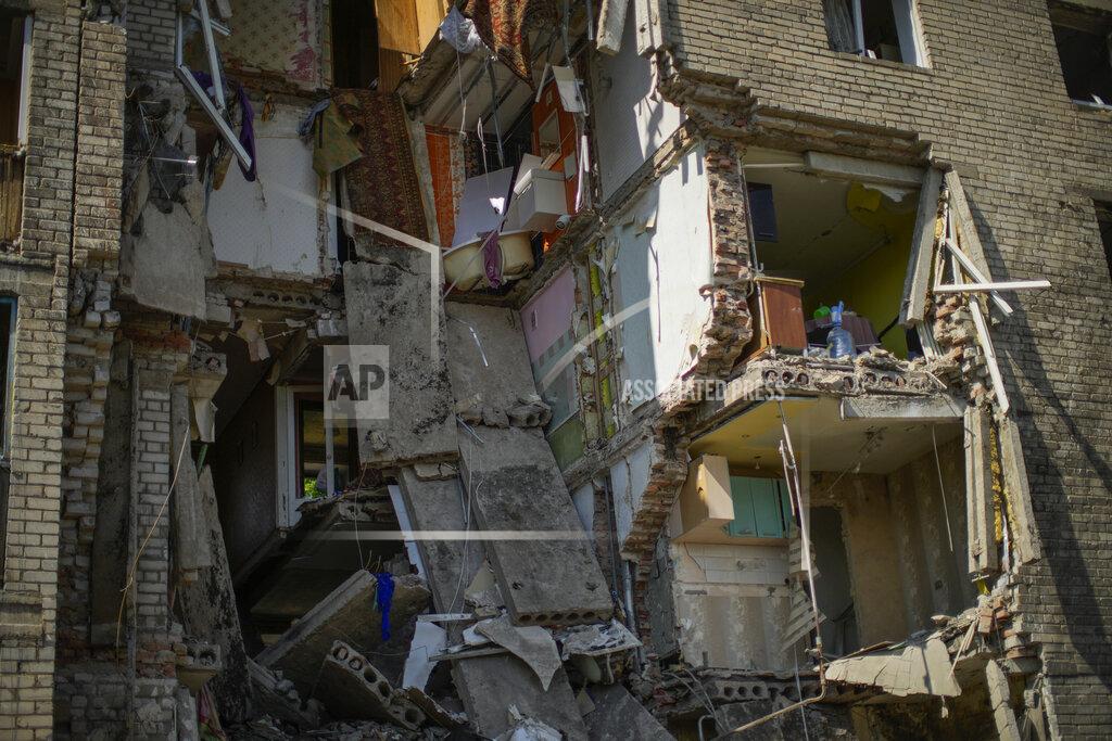 Francisco Seco Debris hangs from a residential building heavily damaged in a Russian bombing in Bakhmut, eastern Ukraine, Tuesday, May 24, 2022. The town of Bakhmut has been coming under increasing artillery strikes, particularly over the last week, as Russian forces try to press forward to encircle the city of Sieverodonetsk to the northeast. (AP Photo/Francisco Seco)