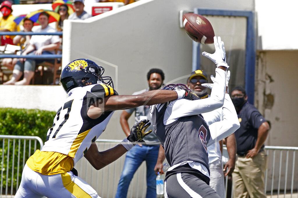 Rogelio V. Solis Alabama A&M wide receiver Zabrian Moore (8) reaches for an over the shoulder touchdown reception in front of Arkansas-Pine Bluff defensive back Andre Fuller (37) during the first half of the Southwestern Athletic Conference NCAA college football game, Saturday, May 1, 2021, in Jackson, Miss. (AP Photo/Rogelio V. Solis)