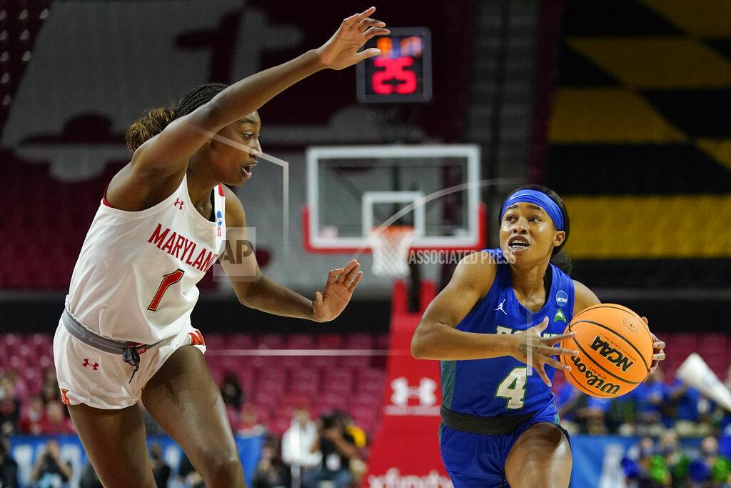 Julio Cortez Florida Gulf Coast guard Tishara Morehouse (4) drives against Maryland guard Diamond Miller (1) during the first half of a college basketball game in the second round of the NCAA tournament, Sunday, March 20, 2022, in College Park, Md. (AP Photo/Julio Cortez)