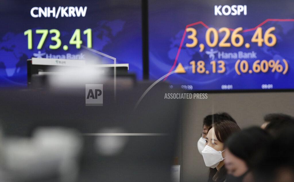 Lee Jin-Man Currency traders watch their computer monitors near the screens showing the Korea Composite Stock Price Index (KOSPI), right, and the foreign exchange rate at the foreign exchange dealing room in Seoul, South Korea, Friday, March 26, 2021. Shares were higher across Asia on Friday after a strong gains on Wall Street driven by hopes for a powerful recovery from the pandemic. (AP Photo/Lee Jin-man)