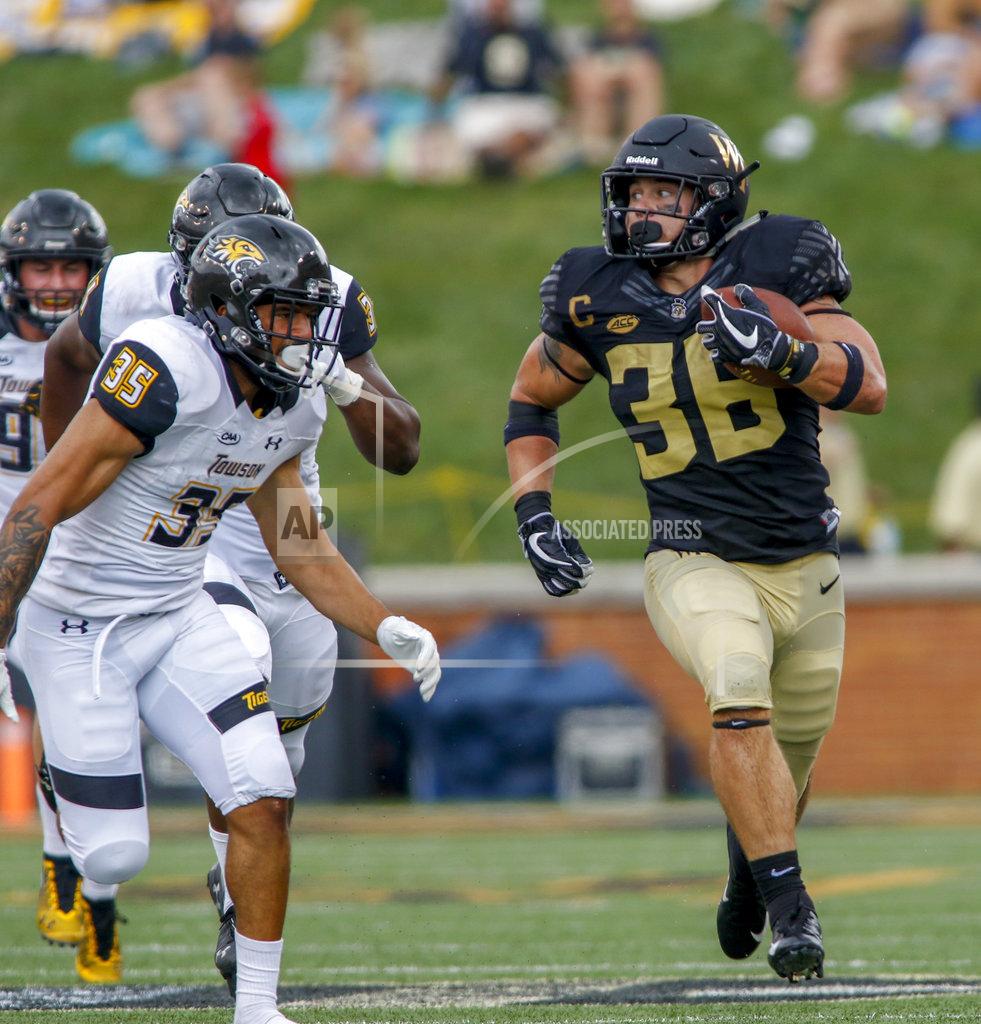 Nell Redmond Wake Forest running back Cade Carney, right, carries the football for a first down as Towson defensive back Coby Tippett pursues him in the second half of an NCAA college football game in Winston-Salem, N.C., Saturday, Sept. 8, 2018. (AP Photo/Nell Redmond)