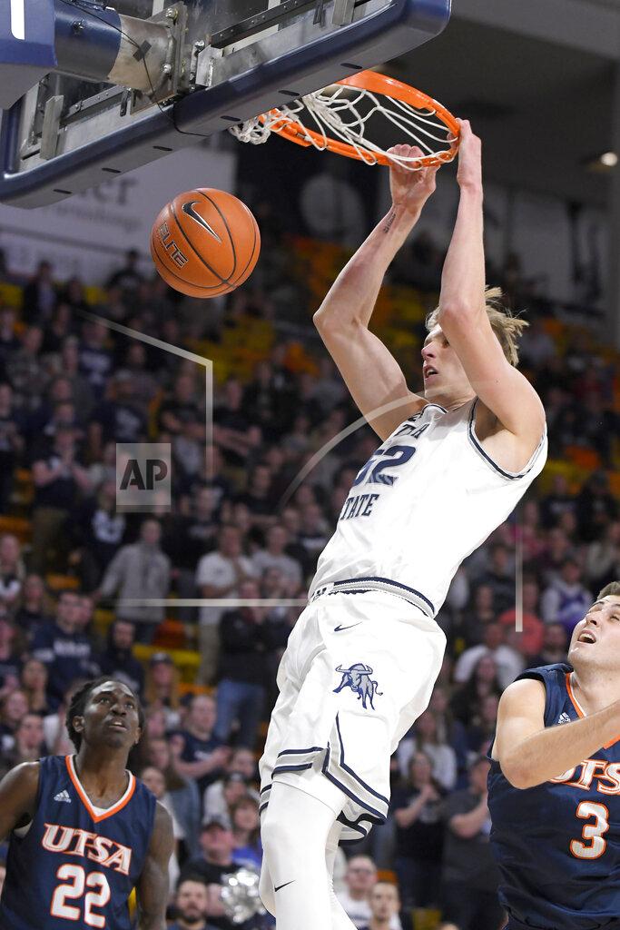 Eli Lucero Utah State center Kuba Karwowski (52) dunks the ball as UTSA guard Keaton Wallace (22) and forward Byron Frohnen (3) defend during the first half of an NCAA college basketball game Monday, Nov. 18, 2019, in Logan, Utah. (AP Photo/Eli Lucero)