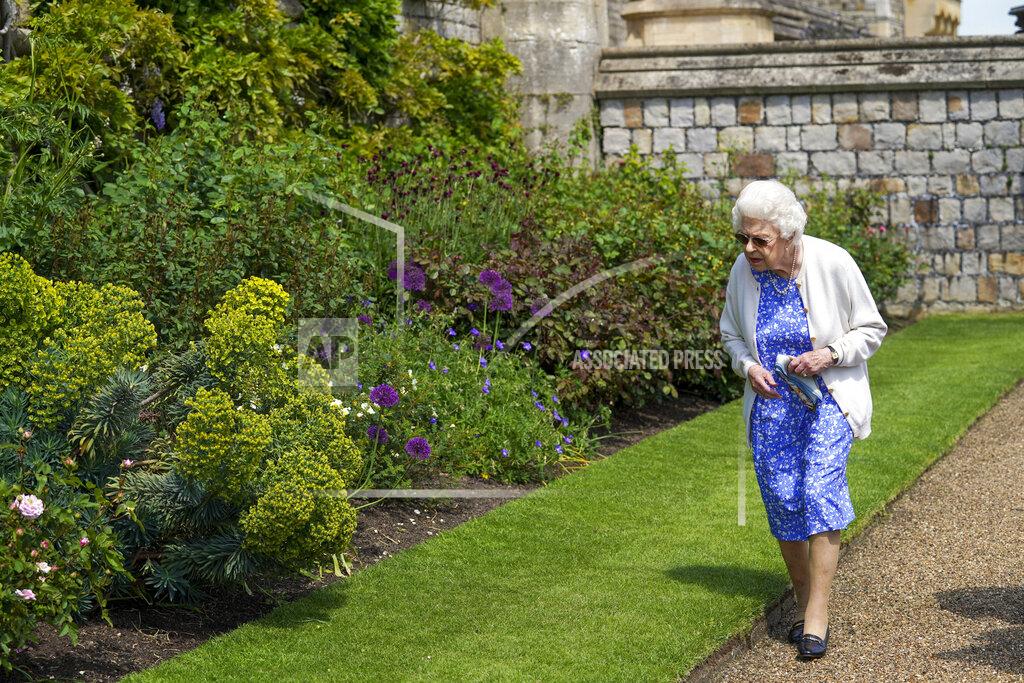Steve Parsons Britain's Queen Elizabeth II views the garden border after receiving a Duke of Edinburgh rose, at Windsor Castle, England, Wednesday June 9, 2021. The newly bred deep pink commemorative rose has officially been named in memory of the late Prince Philip Duke of Edinburgh. A royalty from the sale of each rose will go to The Duke of Edinburgh's Award Living Legacy Fund to support young people taking part in the Duke of Edinburgh Award scheme. (Steve Parsons/Pool via AP)